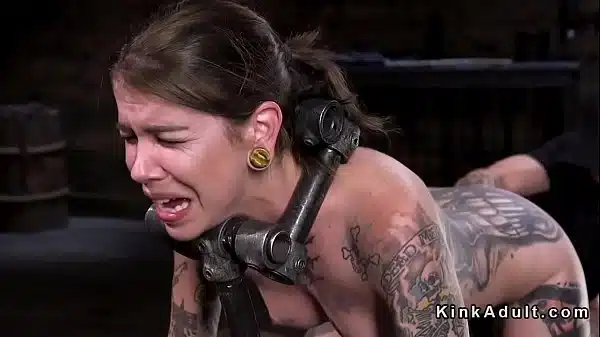 Brunette Slave Bound In Metal Device With Dildo Shoved In Her Pussy Gets Hard Whipped