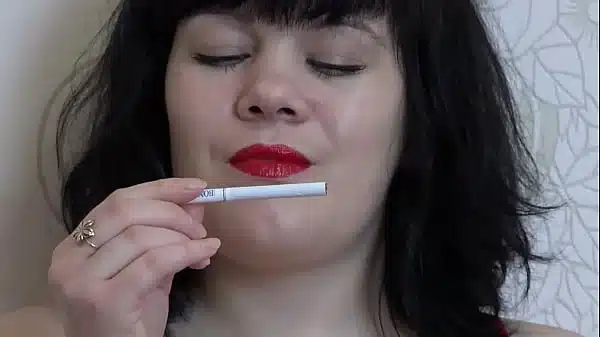 A Girl In High Heeled Sandals Fucks With A Big Rubber Dick She Then Smokes With Bright Red Lips